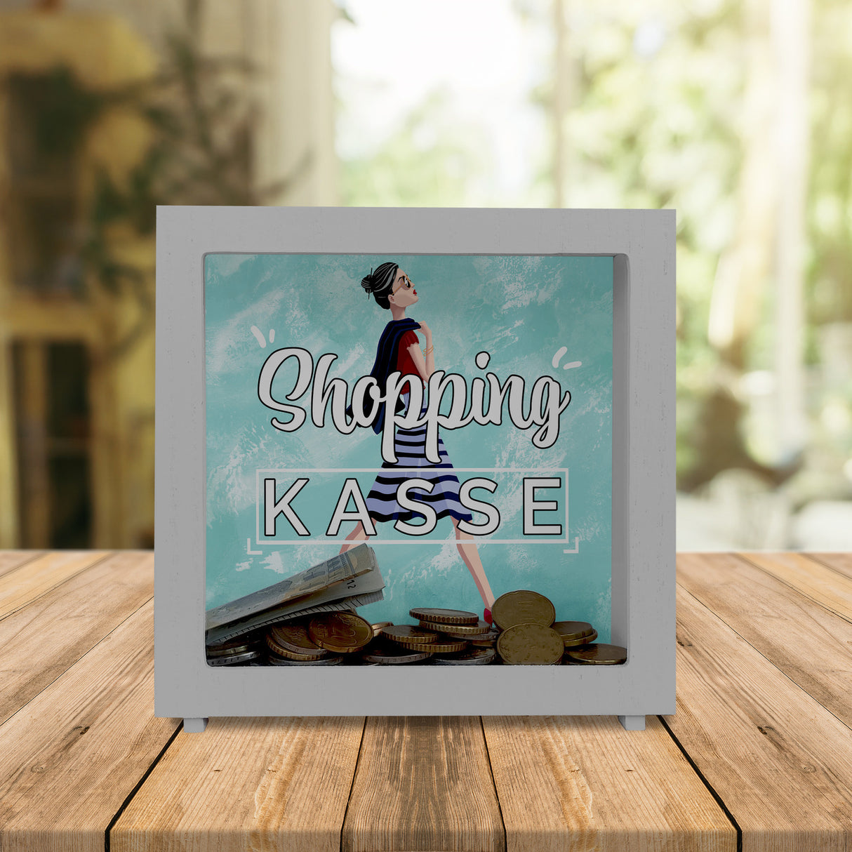 Spardose aus Keramik mit Diva Motiv vor blauem Hintergrund - Shopping Kasse