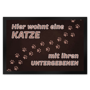 Hier wohnt eine Katze mit ihren Untergebenen Fußmatte mit Pfotenabdrücken