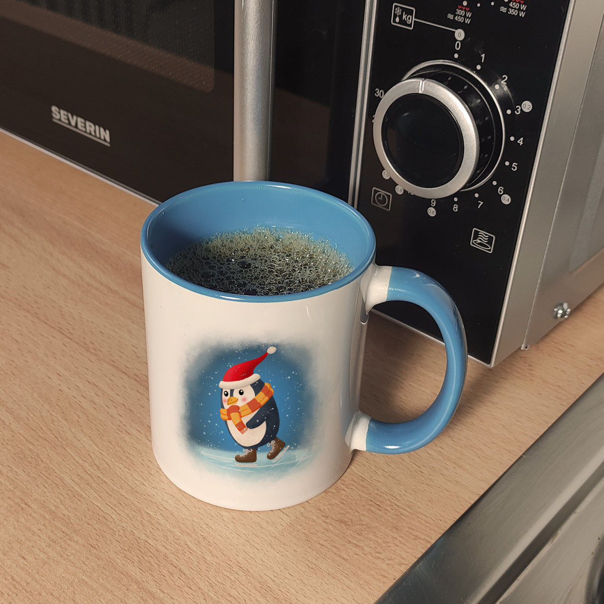 Pinguin mit Weihnachtsmütze und Schlittschuhen Kaffeebecher