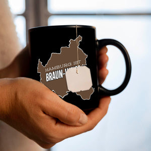 St. Pauli Tasse in Schwarz mit Spruch Hamburg ist braun-weiss