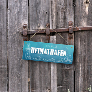Metallschild mit maritimen Motiv und Spruch: Heimathafen
