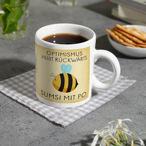 Optimismus heißt rückwärts Sumsi mit Po Biene Kaffeebecher mit Spruch